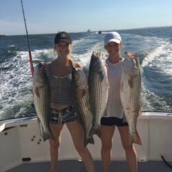 Coral_Coral holding keeper striped bass caught in Newport RI